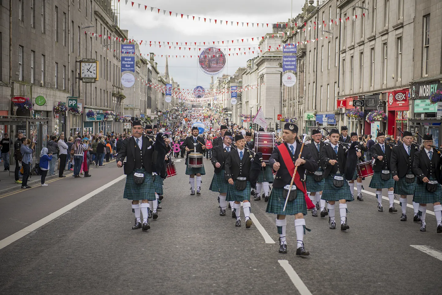 Pipers leading the Celebrate Aberdeen parade down Union Street